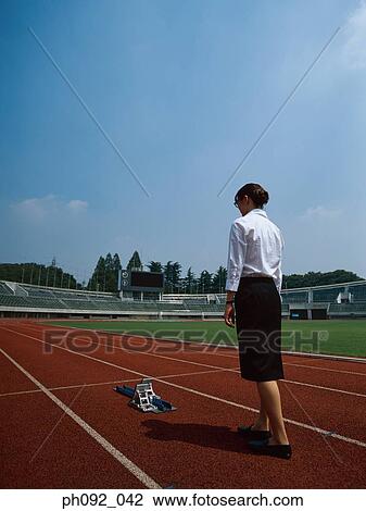 Businesswoman walking towards starting block View Large Photo Image Stock Image - Businesswoman walking towards starting block . Fotosearch