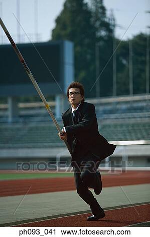 Stock Image - Businessman pole vaulter. Fotosearch
