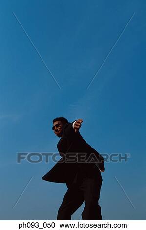 Stock Image - Businessman throwing a discus. Fotosearch