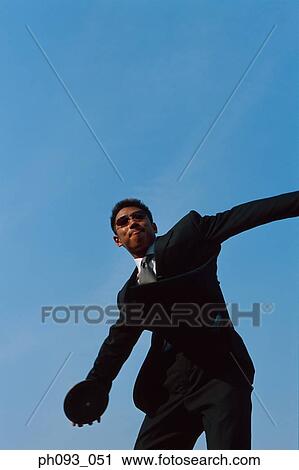 Businessman throwing a discus View Large Photo Image Stock Image - Businessman throwing a discus. Fotosearch