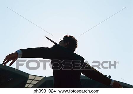 Picture - Businessman throwing a javelin. Fotosearch