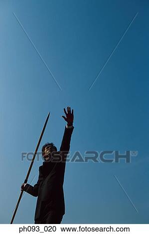 Businessman throwing a javelin View Large Photo Image Stock Image - Businessman throwing a javelin. Fotosearch