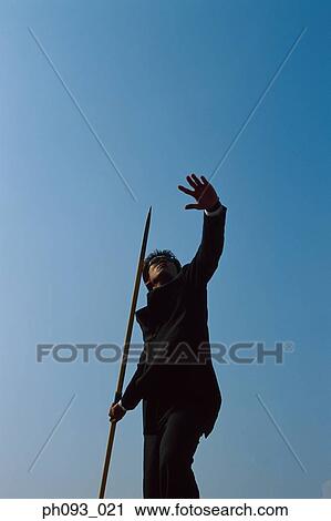 Businessman throwing a javelin View Large Photo Image Stock Image - Businessman throwing a javelin. Fotosearch