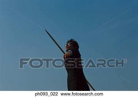 Businessman throwing a javelin View Large Photo Image Stock Image - Businessman throwing a javelin. Fotosearch