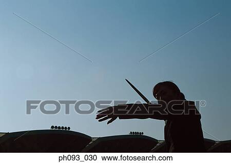 Stock Image - Businessman throwing a javelin, silhouette. Fotosearch