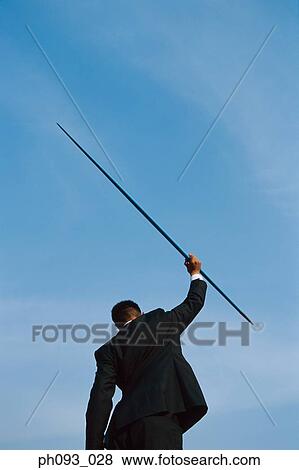 Businessman throwing a javelin View Large Photo Image Stock Photo - Businessman throwing a javelin. Fotosearch