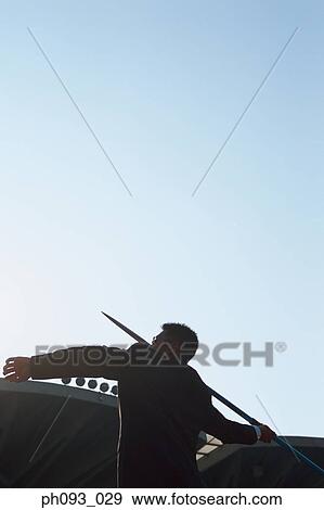 Businessman throwing a javelin View Large Photo Image Stock Photo - Businessman throwing a javelin. Fotosearch
