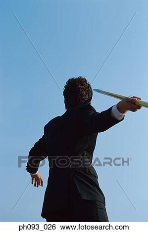 Businessman throwing a javelin View Large Photo Image Stock Photograph - Businessman throwing a javelin. Fotosearch