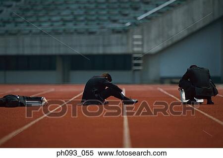 Stock Photography - Exhausted businessmen on track. Fotosearch
