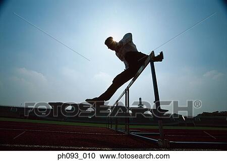 Silhouette of businessman leaping hurdle View Large Photo Image Stock Image - Silhouette of businessman leaping hurdle. Fotosearch