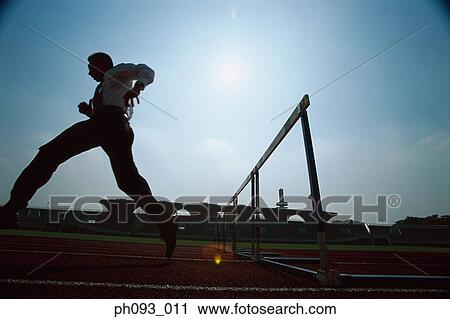 Silhouette of businessman leaping hurdle View Large Photo Image Stock Image - Silhouette of businessman leaping hurdle. Fotosearch