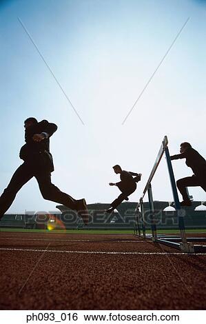 Silhouette of businessmen leaping hurdle View Large Photo Image Stock Photograph - Silhouette of businessmen leaping hurdle. Fotosearch