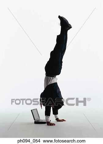 Businessman hand stands looking at computer notebook View Large Photo Image Picture - Businessman hand stands looking at computer notebook. Fotosearch