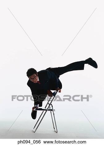 Businessman hand stands on chair, legs apart View Large Photo Image Stock Photograph - Businessman hand stands on chair, legs apart. Fotosearch