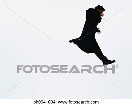 Young businessman leaping in air View Large Photo Image Picture - Young businessman leaping in air. Fotosearch