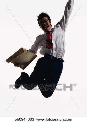 Young businessman leaping in air, holding a envelope View Large Photo Image Stock Image - Young businessman leaping in air, holding a envelope. Fotosearch