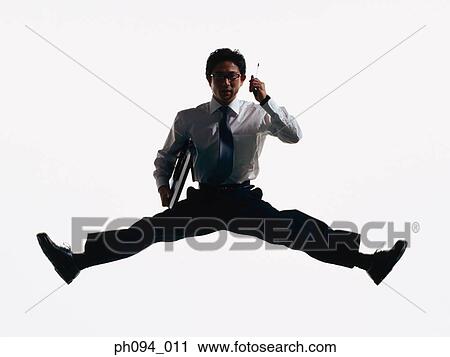 Young businessman leaping in air, holding cell phone and briefcase View Large Photo Image Stock Image - Young businessman leaping in air, holding cell phone and briefcase. Fotosearch