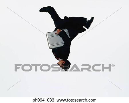 Young businessman leaping in air, holding a briefcase View Large Photo Image Stock Image - Young businessman leaping in air, holding a briefcase. Fotosearch