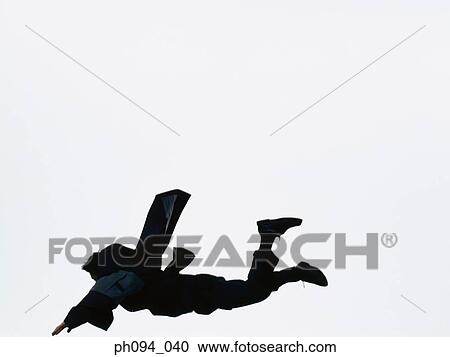 Stock Image - Young businessman leaping in air. Fotosearch