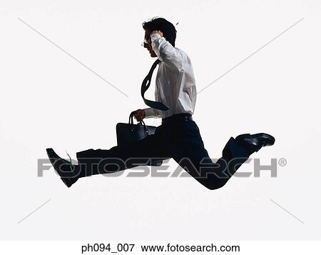 Young businessman leaping in air, holding cell phone and briefcase View Large Photo Image Stock Photo - Young businessman leaping in air, holding cell phone and briefcase. Fotosearch