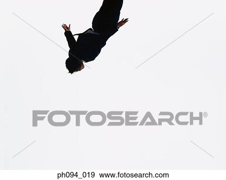 Young businessman leaping in air View Large Photo Image Stock Photo - Young businessman leaping in air. Fotosearch