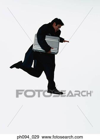 Stock Photo - Young businessman leaping in air, holding a briefcase. Fotosearch