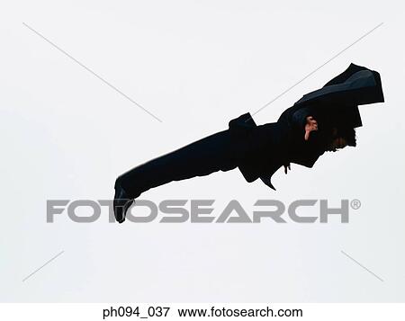 Stock Photo - Young businessman leaping in air. Fotosearch
