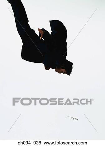 Young businessman leaping in air View Large Photo Image Stock Photo - Young businessman leaping in air. Fotosearch