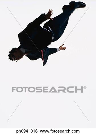 Stock Photograph - Young businessman leaping in air. Fotosearch