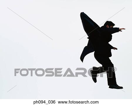 Young businessman leaping in air View Large Photo Image Stock Photograph - Young businessman leaping in air. Fotosearch