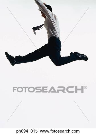 Young businessman leaping in air View Large Photo Image Stock Photography - Young businessman leaping in air. Fotosearch
