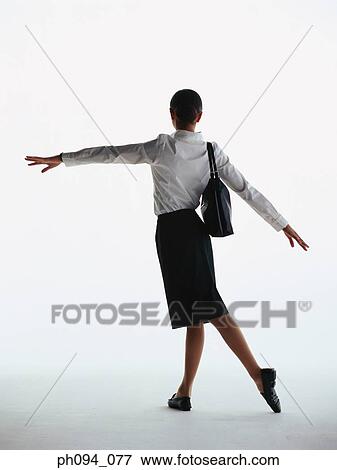 Stock Photo - Young businesswoman in dancing posture. Fotosearch