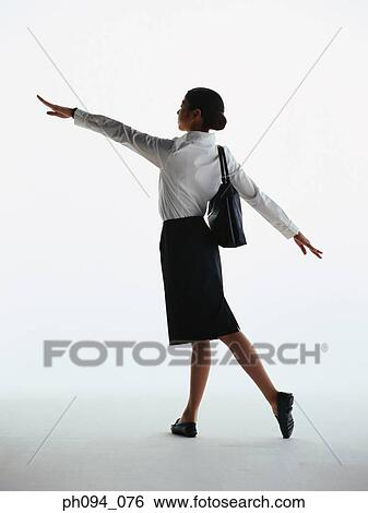 Stock Photograph - Young businesswoman in dancing posture. Fotosearch