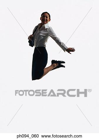 Young businesswoman leaping in air, holding a handbag View Large Photo Image Stock Image - Young businesswoman leaping in air, holding a handbag . Fotosearch