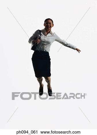 Young businesswoman leaping in air, holding a handbag View Large Photo Image Stock Image - Young businesswoman leaping in air, holding a handbag . Fotosearch