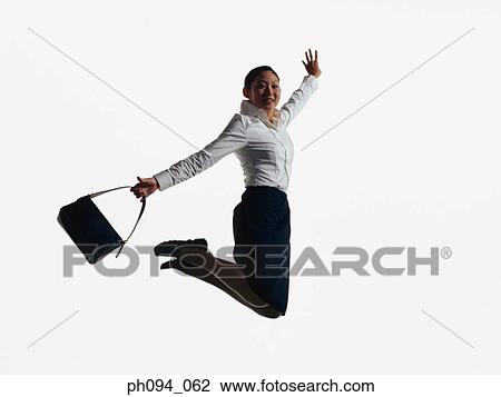 Young businesswoman leaping in air, holding a handbag View Large Photo Image Stock Image - Young businesswoman leaping in air, holding a handbag . Fotosearch