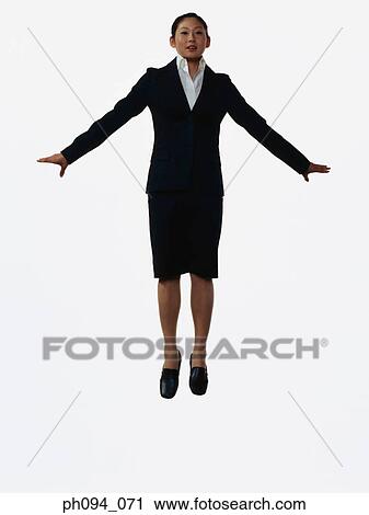 Young businesswoman leaping in air View Large Photo Image Stock Image - Young businesswoman leaping in air. Fotosearch