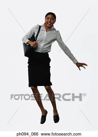 Young businesswoman leaping in air, holding a handbag View Large Photo Image Stock Photograph - Young businesswoman leaping in air, holding a handbag . Fotosearch