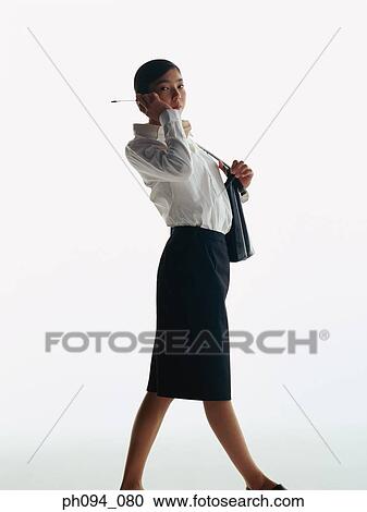 Stock Image - Young businesswoman with cell phone. Fotosearch
