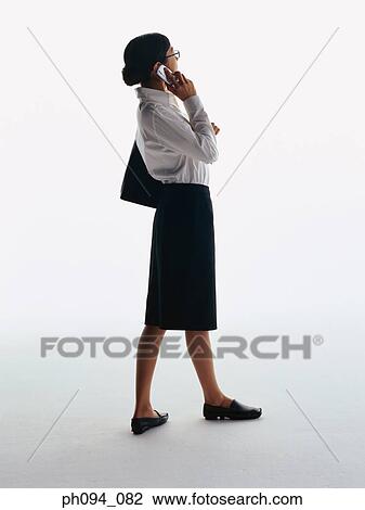 Stock Image - Young businesswoman with cell phone. Fotosearch