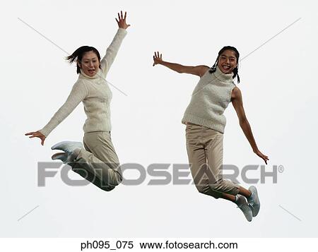 Two young Asian women in pants & sweat-shirts, jumping in mid-air View Large Photo Image Stock Photography - Two young Asian women in pants & sweat-shirts, jumping in mid-air. Fotosearch