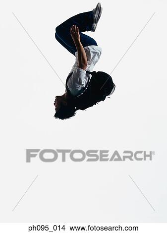 Young Asian man in jeans & t-shirt, carrying haversack, jumping in mid-air View Large Photo Image Picture - Young Asian man in jeans & t-shirt, carrying haversack, jumping in mid-air. Fotosearch