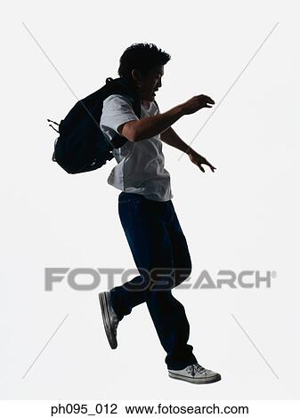 Young Asian man in jeans & t-shirt, carrying haversack, jumping in mid-air View Large Photo Image Stock Image - Young Asian man in jeans & t-shirt, carrying haversack, jumping in mid-air. Fotosearch