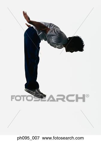 Young Asian man in jeans & t-shirt, jumping in mid-air View Large Photo Image Stock Photo - Young Asian man in jeans & t-shirt, jumping in mid-air. Fotosearch