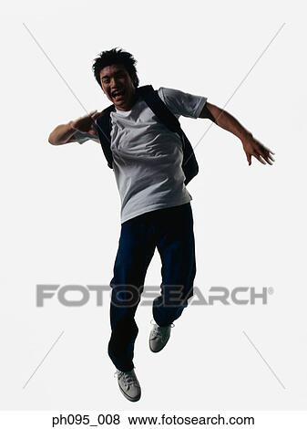 Young Asian man in jeans & t-shirt, carrying haversack, jumping in mid-air View Large Photo Image Stock Photo - Young Asian man in jeans & t-shirt, carrying haversack, jumping in mid-air. Fotosearch