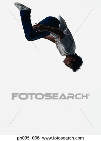 Young Asian man in jeans & t-shirt, jumping in mid-air View Large Photo Image Stock Photograph - Young Asian man in jeans & t-shirt, jumping in mid-air. Fotosearch