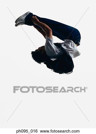 Young Asian man in jeans & t-shirt, carrying haversack, jumping in mid-air View Large Photo Image Stock Photograph - Young Asian man in jeans & t-shirt, carrying haversack, jumping in mid-air. Fotosearch
