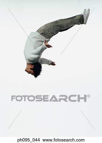 Young Asian man in pants & sweat-shirt, jumping in mid-air View Large Photo Image Picture - Young Asian man in pants & sweat-shirt, jumping in mid-air. Fotosearch