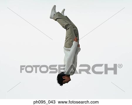 Young Asian man in pants & sweat-shirt, jumping in mid-air View Large Photo Image Stock Image - Young Asian man in pants & sweat-shirt, jumping in mid-air. Fotosearch
