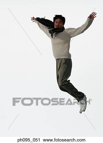 Young Asian man in pants & sweat-shirt and scarf, jumping in mid-air View Large Photo Image Stock Image - Young Asian man in pants & sweat-shirt and scarf, jumping in mid-air. Fotosearch